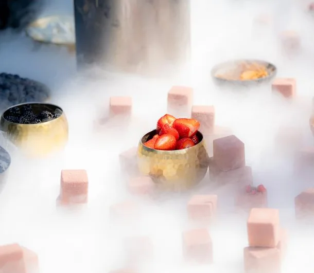 Strawberries in a gold bowl in a cloud of cold fog